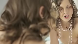 A brunette with pointy nipples pulls on a rubber cock in the video
